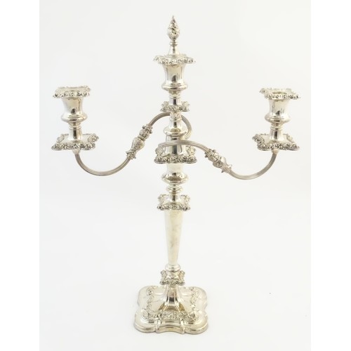 556A - A silver plate table candelabra with two scrolling branches and acanthus scroll detail. Approx 21