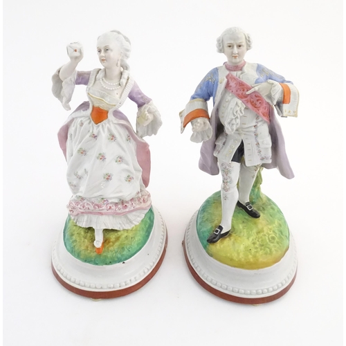 100 - A pair of Continental porcelain figures modelled as a lady and gentleman with flower baskets. Togeth... 