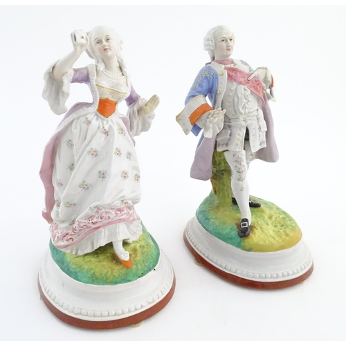 100 - A pair of Continental porcelain figures modelled as a lady and gentleman with flower baskets. Togeth... 