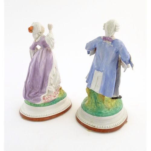 100 - A pair of Continental porcelain figures modelled as a lady and gentleman with flower baskets. Togeth... 