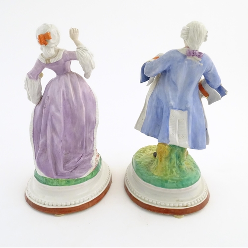 100 - A pair of Continental porcelain figures modelled as a lady and gentleman with flower baskets. Togeth... 