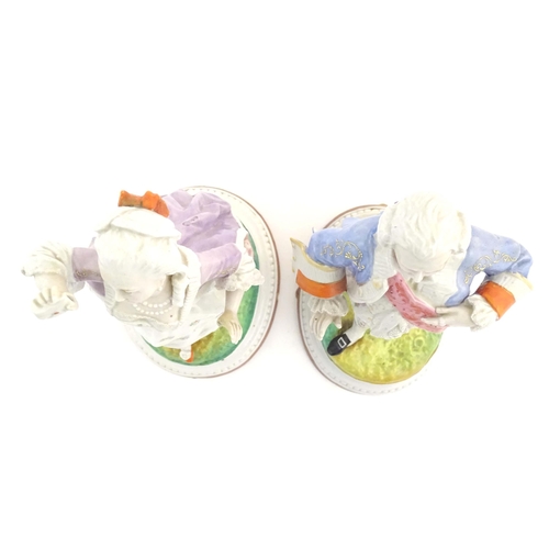 100 - A pair of Continental porcelain figures modelled as a lady and gentleman with flower baskets. Togeth... 