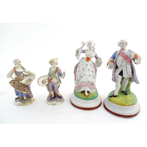 100 - A pair of Continental porcelain figures modelled as a lady and gentleman with flower baskets. Togeth... 