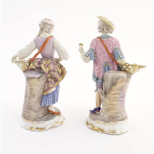 100 - A pair of Continental porcelain figures modelled as a lady and gentleman with flower baskets. Togeth... 