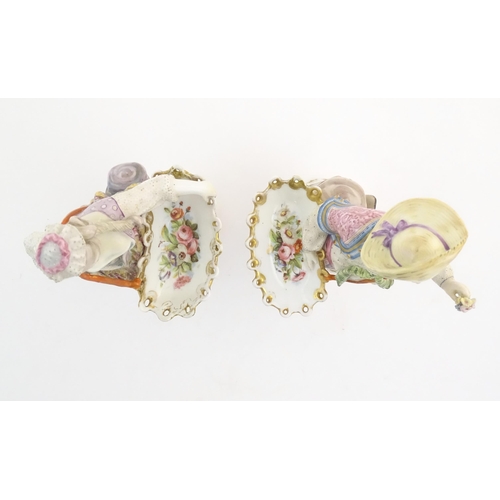 100 - A pair of Continental porcelain figures modelled as a lady and gentleman with flower baskets. Togeth... 