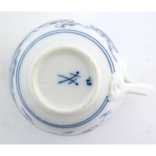 101 - A Meissen blue and white cup and saucer in the onion pattern. With blue crossed sword mark under. Cu... 