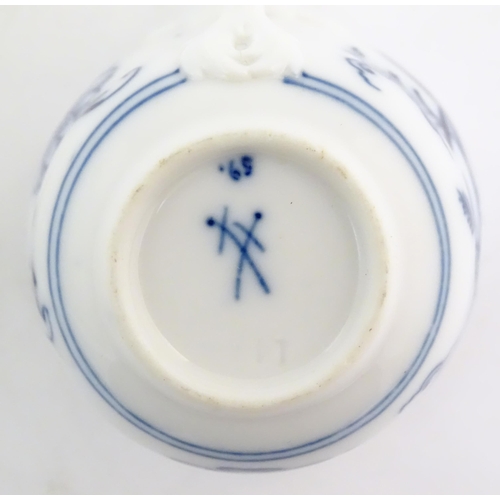 101 - A Meissen blue and white cup and saucer in the onion pattern. With blue crossed sword mark under. Cu... 