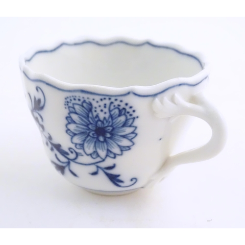 101 - A Meissen blue and white cup and saucer in the onion pattern. With blue crossed sword mark under. Cu... 