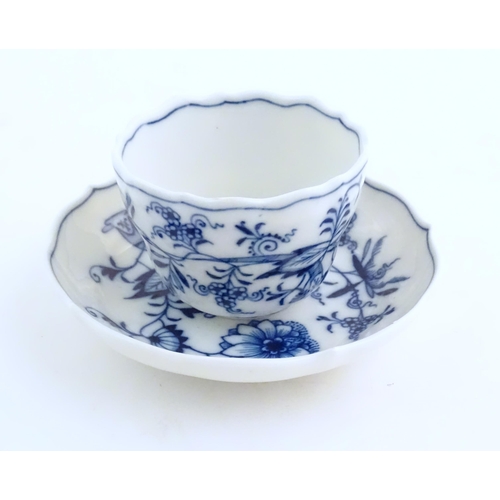 101 - A Meissen blue and white cup and saucer in the onion pattern. With blue crossed sword mark under. Cu... 