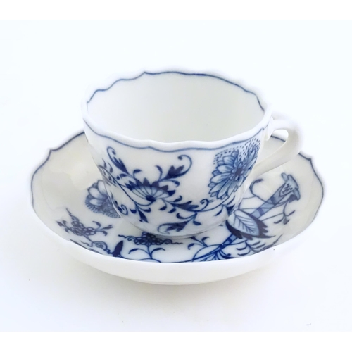 101 - A Meissen blue and white cup and saucer in the onion pattern. With blue crossed sword mark under. Cu... 