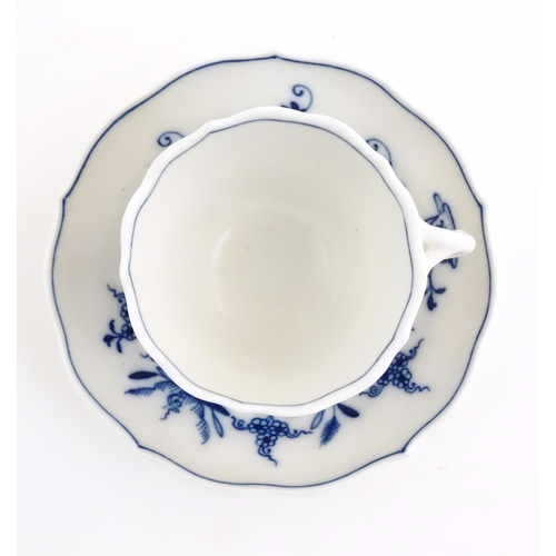 101 - A Meissen blue and white cup and saucer in the onion pattern. With blue crossed sword mark under. Cu... 