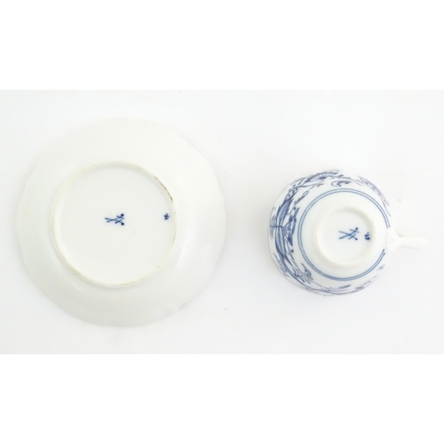 101 - A Meissen blue and white cup and saucer in the onion pattern. With blue crossed sword mark under. Cu... 