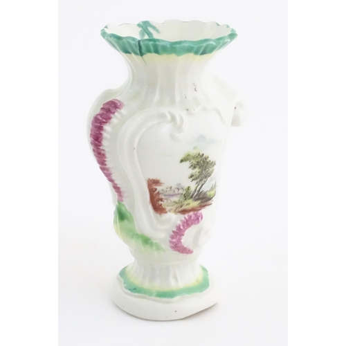 102 - A Rococo style vase of asymmetric form decorated with hand painted landscape scenes in the Derby sty... 