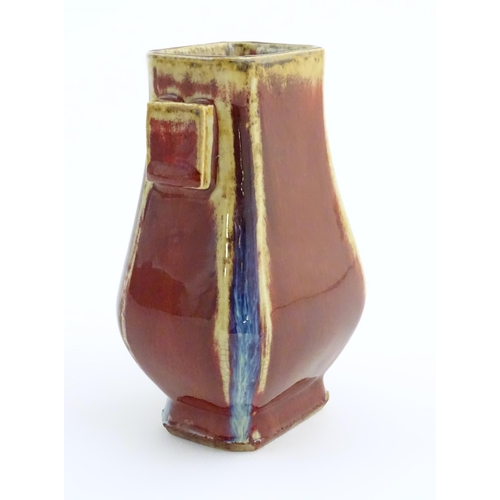 15 - A Chinese sang de boeuf arrow vase of squared form with twin handles. Character marks under. Approx.... 