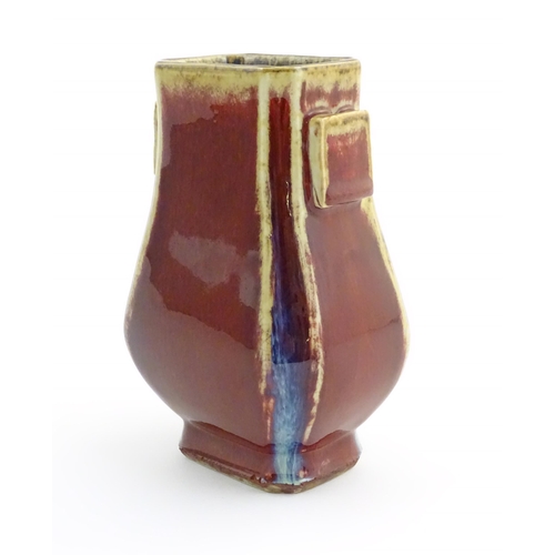 15 - A Chinese sang de boeuf arrow vase of squared form with twin handles. Character marks under. Approx.... 