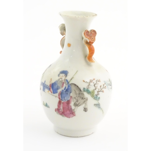 28 - A small Chinese famille rose vase with twin handles of ruyi sceptre form, the body decorated with fi... 