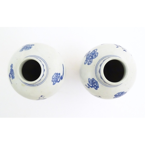 44 - A pair of Chinese blue and white vases decorated with a Chinese dragon parade with figures in a land... 