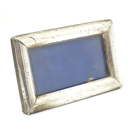 420 - An easel back photograph frame with silver surround hallmarked Birmingham 1913, maker G & C Ltd. App... 