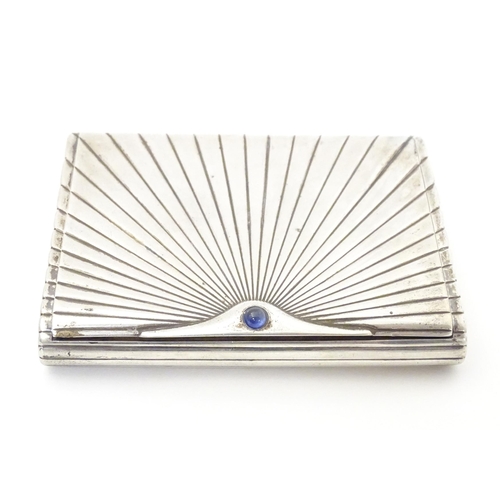 431 - An Art Deco white metal cigarette case with blue sapphire cabochon to clasp. Approx. 4