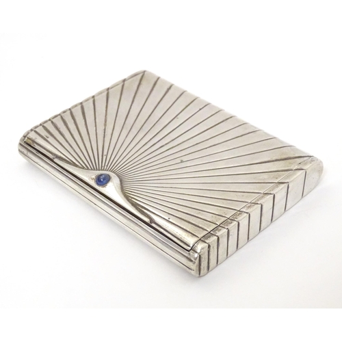 431 - An Art Deco white metal cigarette case with blue sapphire cabochon to clasp. Approx. 4