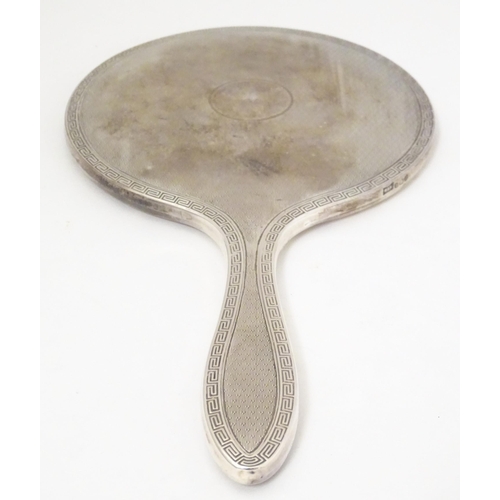 440 - A silver hand mirror with engine turned and Greek key decoration, hallmarked Birmingham 1928, maker ... 