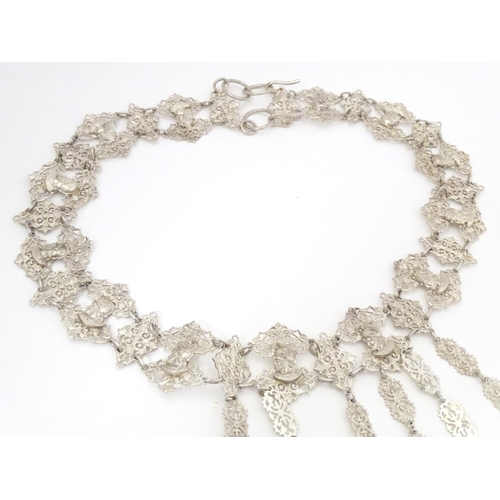 441 - A Dutch silver and white metal chatelaine belt with six hanging chains with scissor keep, aide de me... 