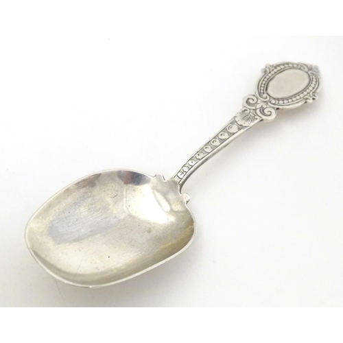 456 - A Victorian silver caddy spoon with oval shield terminal, hallmarked Birmingham 1880, maker George U... 