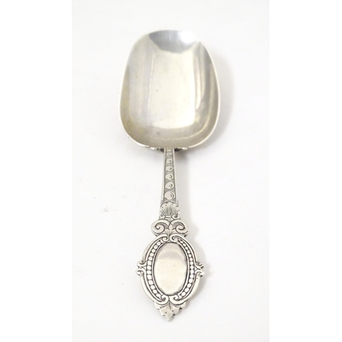 456 - A Victorian silver caddy spoon with oval shield terminal, hallmarked Birmingham 1880, maker George U... 