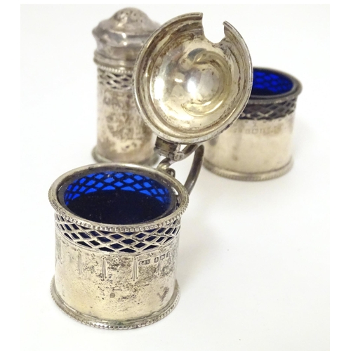 461 - A silver three piece cruet set with blue glass liners comprising salt, mustard and pepperette, hallm... 