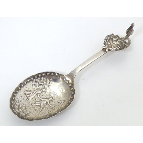 465 - A silver caddy spoon with Dutch landscape scene to bowl, with import marks for London 1901, importer... 