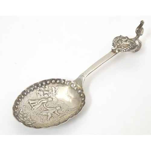 465 - A silver caddy spoon with Dutch landscape scene to bowl, with import marks for London 1901, importer... 