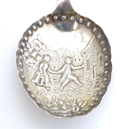 465 - A silver caddy spoon with Dutch landscape scene to bowl, with import marks for London 1901, importer... 