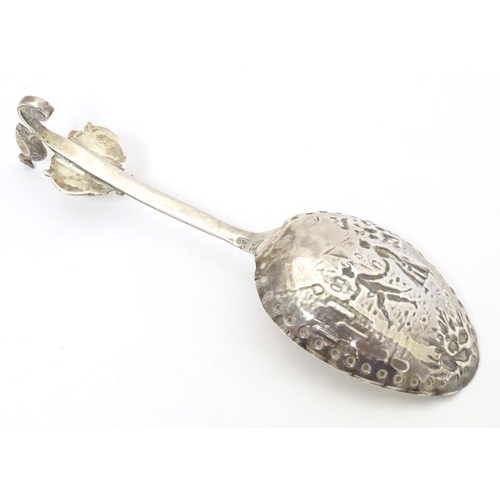 465 - A silver caddy spoon with Dutch landscape scene to bowl, with import marks for London 1901, importer... 