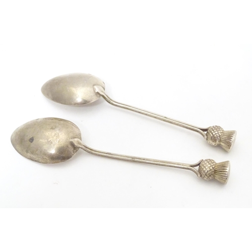 468 - A pair of Scottish silver teaspoons the handles surmounted by thistle detail, hallmarked Glasgow 195... 