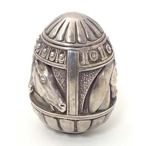 497 - A Continental white metal desk weight of egg form with horse head detail. Marked under Made in Greec... 