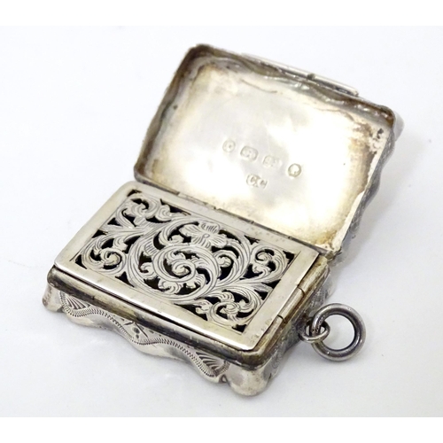 511 - A Victorian silver vinaigrette with engraved decoration opening to reveal grille within, hallmarked ... 