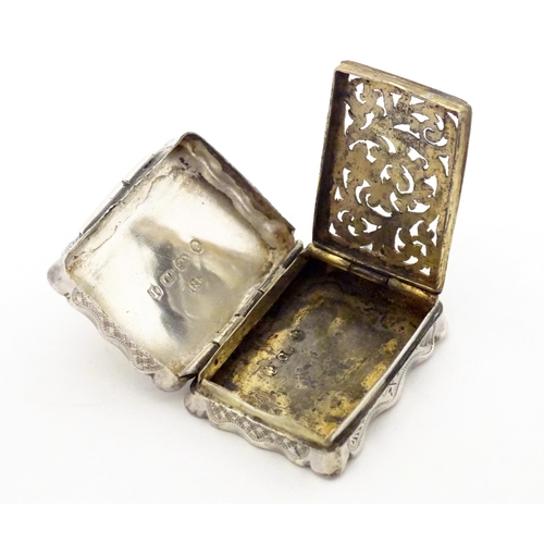 511 - A Victorian silver vinaigrette with engraved decoration opening to reveal grille within, hallmarked ... 