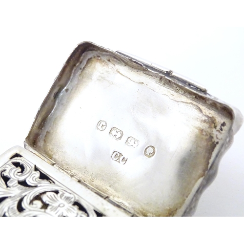 511 - A Victorian silver vinaigrette with engraved decoration opening to reveal grille within, hallmarked ... 