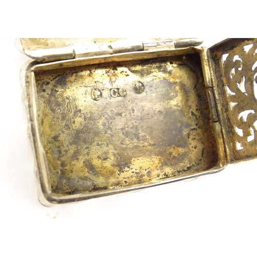 511 - A Victorian silver vinaigrette with engraved decoration opening to reveal grille within, hallmarked ... 