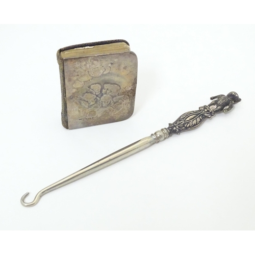 334 - A silver button hook the handle formed as a bear hallmarked Birmingham 1909, maker Adie Lovekin Ltd.... 