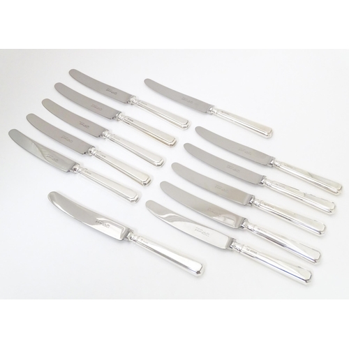 338 - A set of six silver handled knives hallmarked Sheffield 1975, maker Henry Hutton & Co. Together with... 