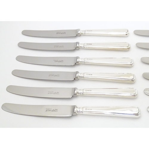 338 - A set of six silver handled knives hallmarked Sheffield 1975, maker Henry Hutton & Co. Together with... 