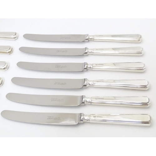 338 - A set of six silver handled knives hallmarked Sheffield 1975, maker Henry Hutton & Co. Together with... 