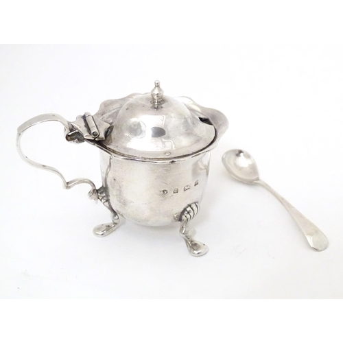 351 - A silver mustard pot with blue glass liner and associated mustard spoon. Hallmarked Birmingham 1900 ... 