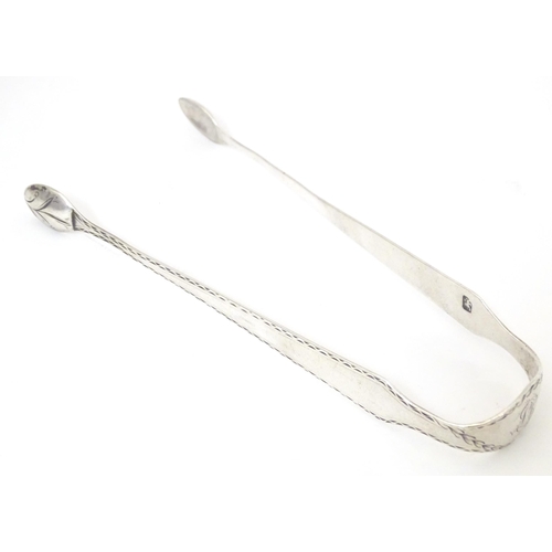 359 - 19thC silver sugar tongs with bright cut decoration, maker W. C. Approx. 5 1/2