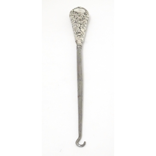 374 - A button hook with embossed silver handle, hallmarked Birmingham 1900. Approx. 11