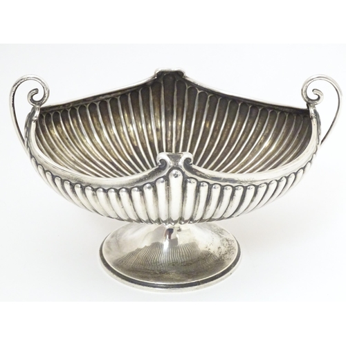 376 - A late 19th / early 20thC silver bowl of fluted oval form with twin handles. Indistinctly signed Bir... 