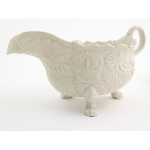 65 - A creamware saucer boat with relief floral and foliate decoration. Together with a Wedgwood sparrow ... 