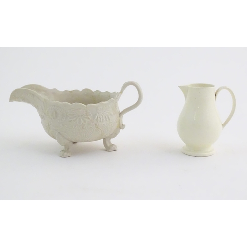 65 - A creamware saucer boat with relief floral and foliate decoration. Together with a Wedgwood sparrow ... 