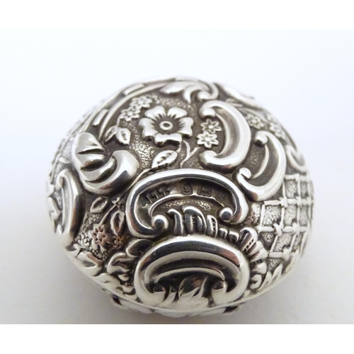 291 - A silver pill box with embossed decoration, hallmarked Birmingham 1904, maker Adie Lovekin Ltd. Appr... 